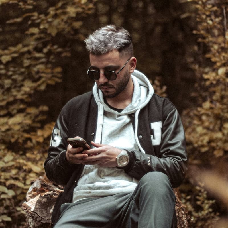 Man using a phone during an online dating therapy session.